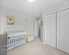 A generous second bedroom with double closet and large windows, easily suited as a child's room or guest space.