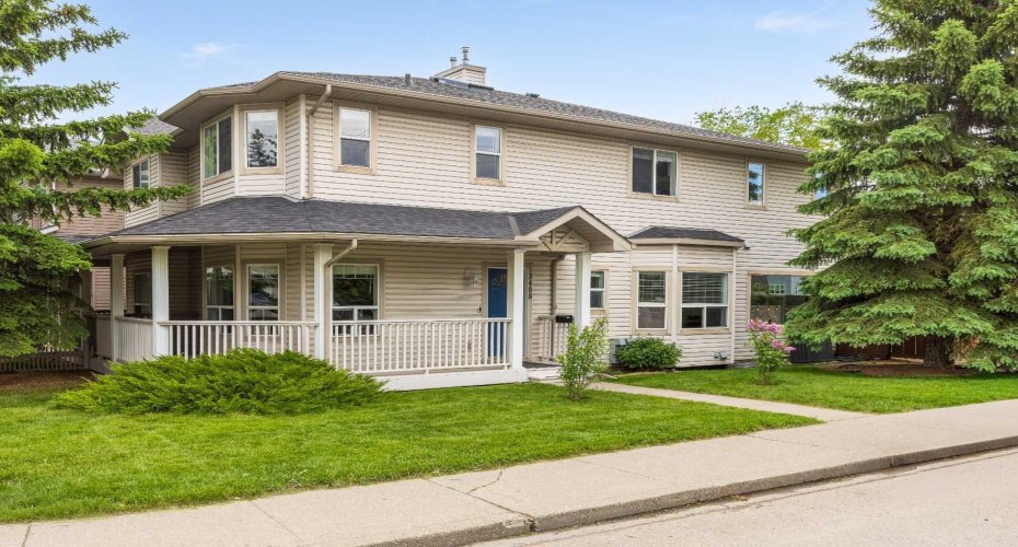 Charming two-storey with a classic wrap around porch and timber accented entry, set on a manicured corner lot framed by mature spruce.