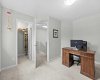 A flexible upper bedroom offering a walk in closet, garden views, and an open outlook to the stairwell landing.