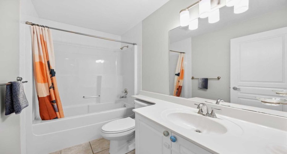 The upstairs four piece main bath is bright and well kept, with a full tub and shower combination.