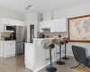 A raised eat up breakfast bar seats three and anchors the open concept main floor, perfect for morning coffee or casual entertaining.
