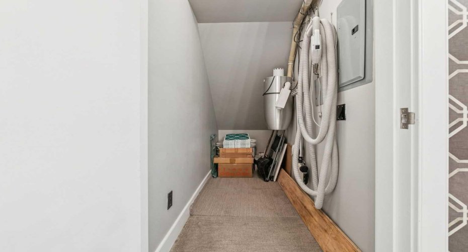 Under stairs storage room with built-in vacuum system.