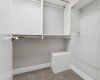Walk-in closet with organizers.