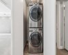 Laundry room with high-end stack washer/dryer.