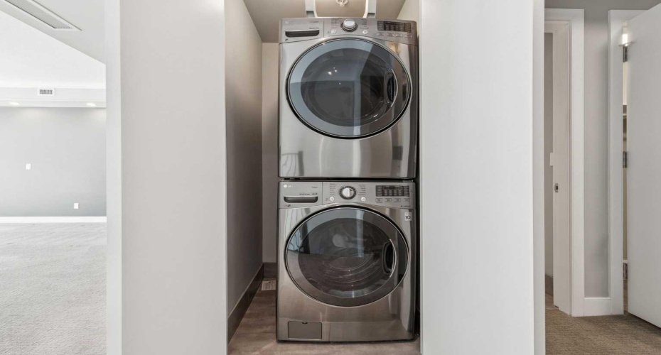 Laundry room with high-end stack washer/dryer.