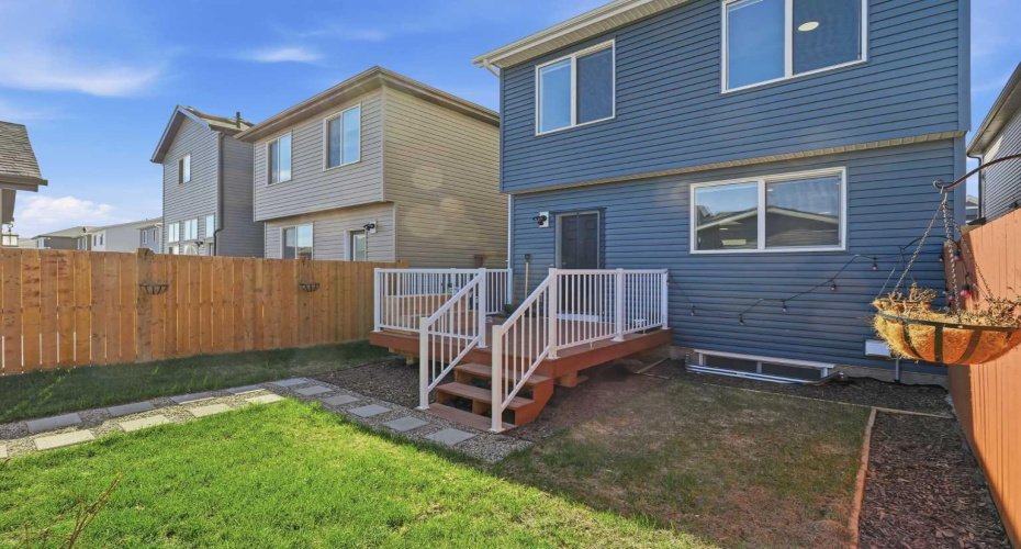 Deck with railings and landscaped yard