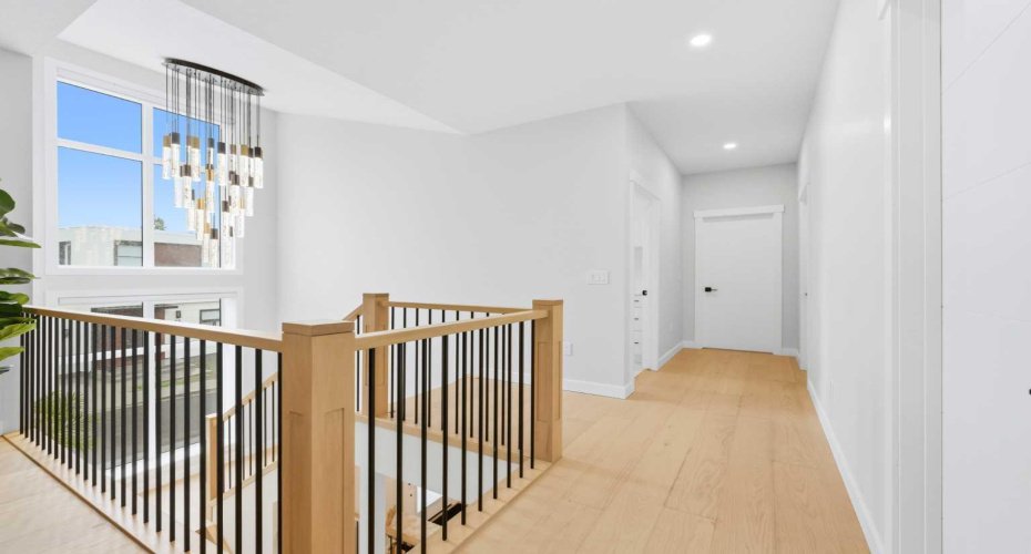 Bright upper-level circulation space connects bedrooms with ease and comfort.