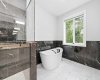 Spa-inspired ensuite showcases a freestanding tub and beautifully appointed details.