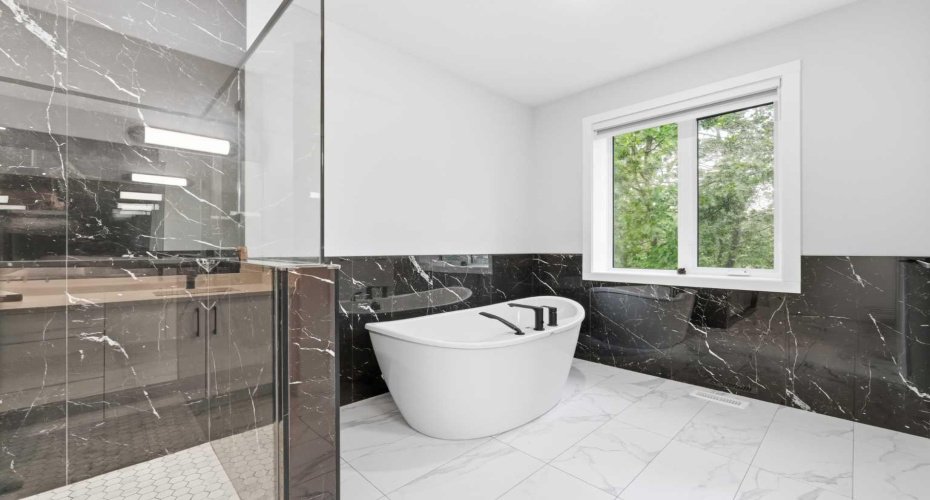Spa-inspired ensuite showcases a freestanding tub and beautifully appointed details.