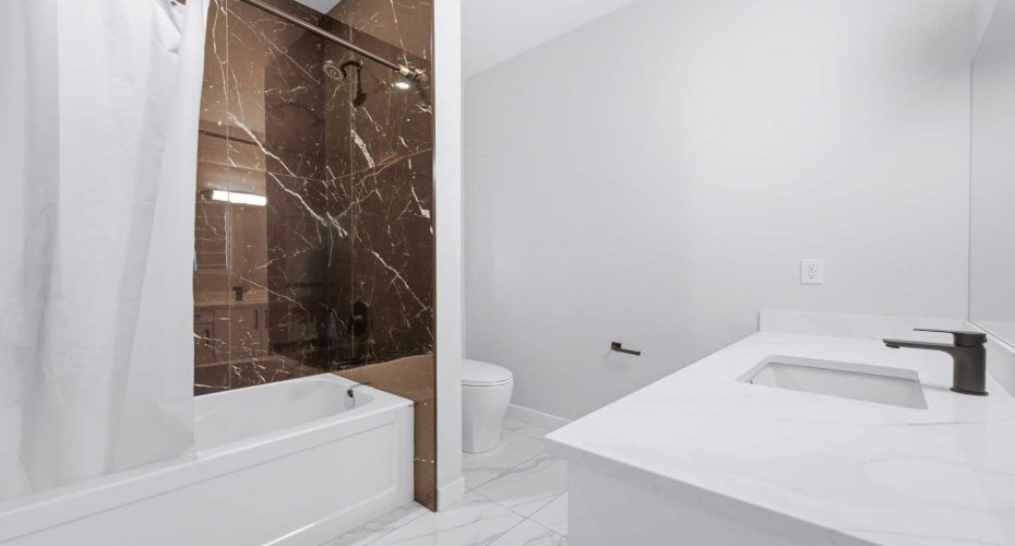 Contemporary full bathroom conveniently serves the upper-level bedrooms.