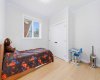 Spacious bedroom offers excellent natural light and functional design.