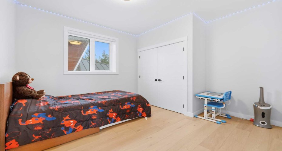 Spacious bedroom offers excellent natural light and functional design.