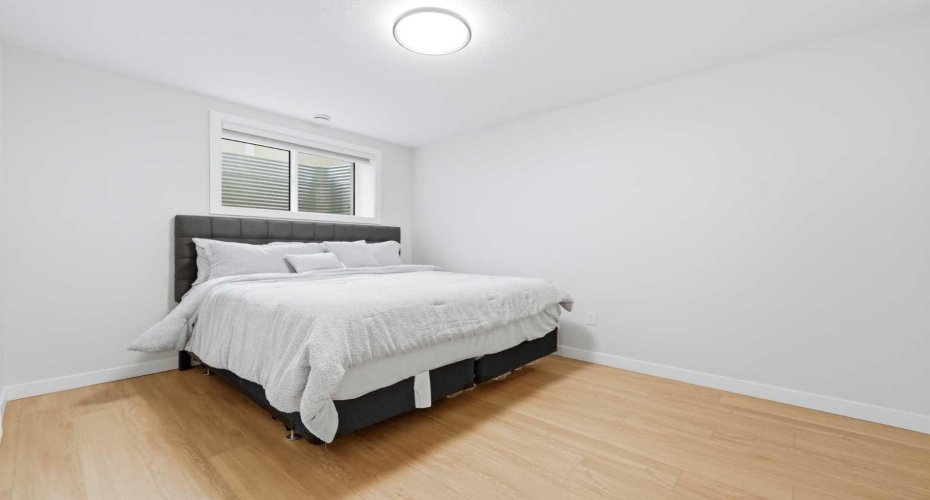 Comfortable lower-level bedroom offers privacy and convenience.