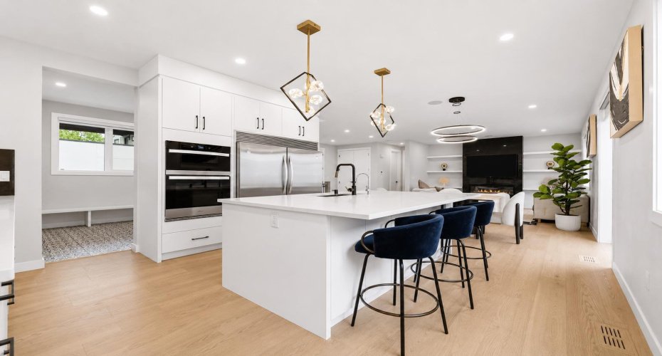 Oversized central island serves as the natural gathering place for family and guests.