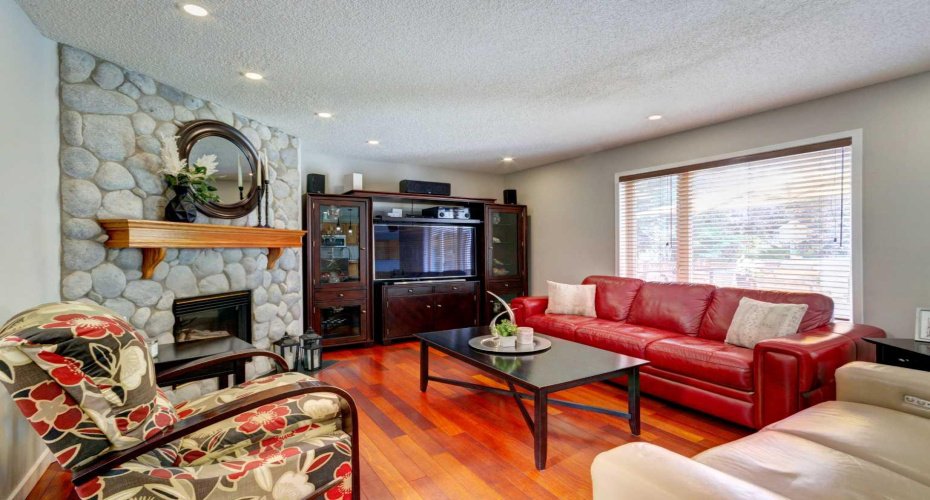 Gas Fireplace with River Rock Surround~A bonus inclusion of the storage cabinet!