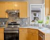 Stainless steel appliances, a tile backsplash with character, and a sunny window over the sink — the little things that make the everyday routine feel a bit brighter.