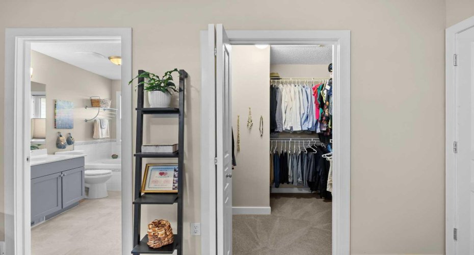 The retreat continues with a walk-in closet and a 4-piece ensuite — his-and-hers hanging space on one side, a soaker tub waiting on the other.