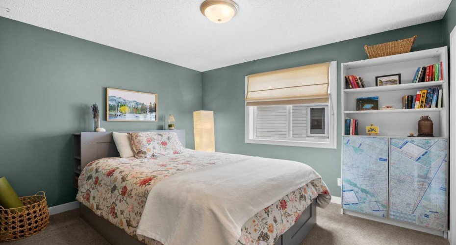 The second bedroom is bright and generously sized, with room for a full bed, bookshelves, and a personality all its own.