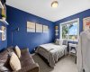 Bedroom three offers the same comfortable footprint — big window, great light, and enough space for a bed and a hangout zone.