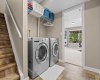 Dedicated laundry with built-in shelving keeps everything above it calm — exactly where a busy family needs it.