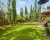 Here's the pie-shaped lot doing what it does best — a sweeping lawn that has hosted more than a few slip-and-slides, yard games, and BBQs worth remembering.