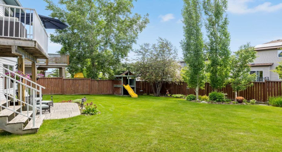 Take it all in: the deck above, the patio below, and green in every direction. Backyards like this don't come along often in Tuscany.