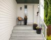 The covered front entry welcomes you home — and puts Tuscany School, St. Basil, and Senator Patrick Burns all within walking distance of this doorstep.