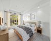 The primary suite is a proper retreat — generous proportions, garden views, and motorized blackout blinds for perfect mornings on your schedule.