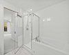 A deep soaker tub beside a glass-and-tile stand-up shower — the kind of ensuite that makes the primary a proper retreat.