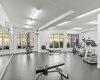 The building's fitness centre looks out onto greenery — cardio, weights, and a rower without leaving home or paying for a membership.
