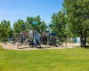 The playground near Guardian Angel School — climbing walls, slides, and shade trees, all steps from your door.