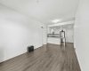 The open-concept layout in full — living, dining, and kitchen in one connected space, warmed underfoot by hydronic in-floor heating.