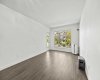 Northeast exposure keeps this space naturally cool through the summer, with oversized windows framing the greenery and direct access to the private patio.