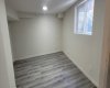 Newly renovated basement with egress window, and L.E.D. light fixtures vinyl planks & egress window