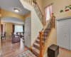 Front door opens into open-to-below staircase.