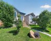 Mature trees and flower beds out front