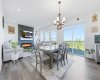 Oversized windows fill the living room with abundant natural light, creating an airy and welcoming space.