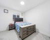 One of the four bedrooms on the upper level, in addition to the dual primary suites...