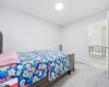One of the four bedrooms on the upper level, in addition to the dual primary suites...