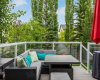 Step out to a spacious deck wrapped in glass railings and framed by towering, mature trees. Comfortable, private, and made for slow summer evenings
