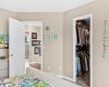 The primary connects to a generous walk-in closet, with sightlines through to the upper hallway. Well-organized, well-lit, and ready for two.