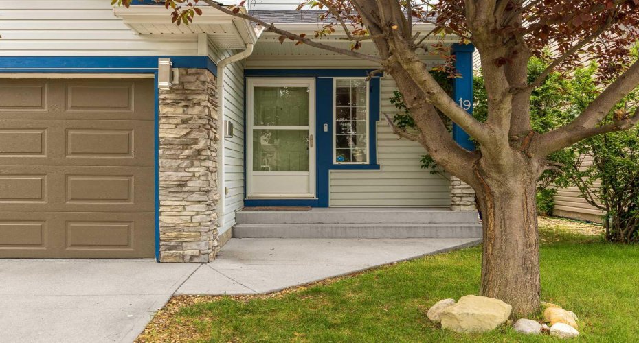 Layered stone, fresh trim, and a covered front step invite you in. It's the kind of entrance that feels cared for before you've even reached the door.