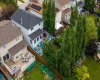 An overhead look reveals the private, tree-lined backyard and generous deck — a green oasis backing onto mature landscaping. Room to breathe, right in the neighbourhood.