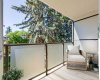 The South facing patio overlooks the common area courtyard but is private thanks to mature trees.