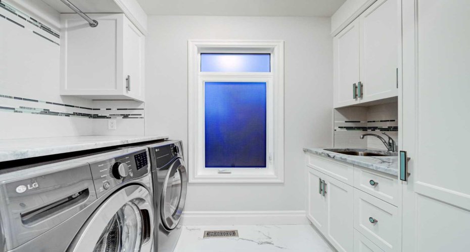 Laundry is conveniently located on 2nd level, and finished with full cabinetry and a sink.