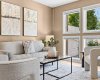A bright, welcoming living space pairs comfortable seating with a wall of windows overlooking the yard.