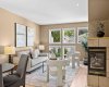 This inviting living area flows easily between the fireplace and the dining space beyond.