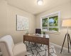 A quiet home office with a window overlooking the street offers a bright, private spot to work or read.
