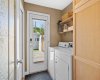 A practical laundry and mud room leads directly outside, keeping everyday comings and goings organized.