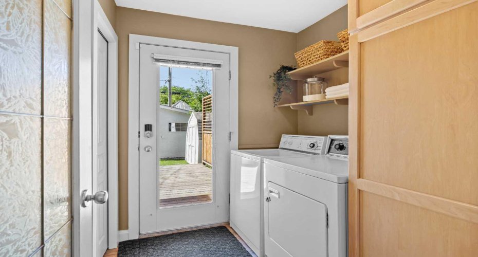A practical laundry and mud room leads directly outside, keeping everyday comings and goings organized.